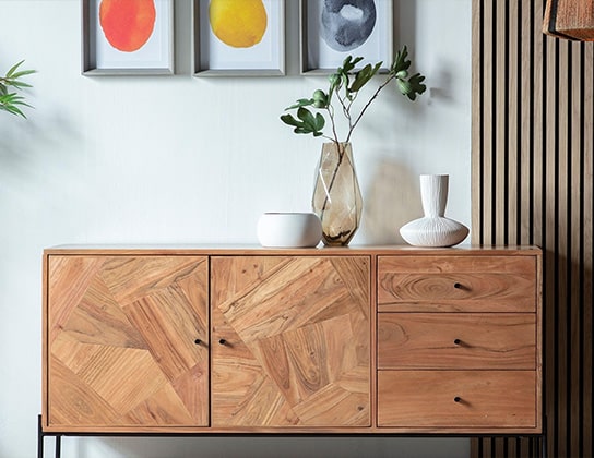 Houten dressoir en schilderijen in de woonkamer van een huis in Eerbeek
